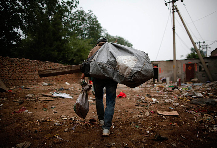 e-waste from the agencies: A garbage collector carries a sack of of items 