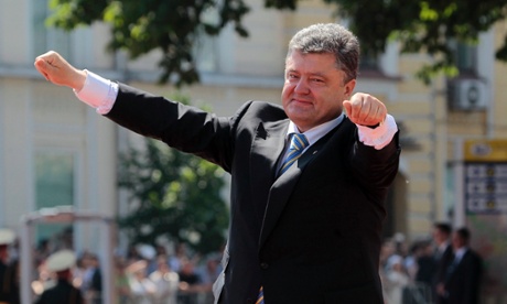 Ukrainian President Petro Poroshenko lifts his arms in greeting after his inauguration ceremony in Sophia Square in Kiev, Ukraine, in June.