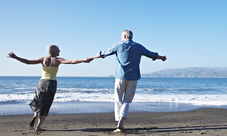 USA, California, Fairfax, Rear view of happy mature couple dancing on beach