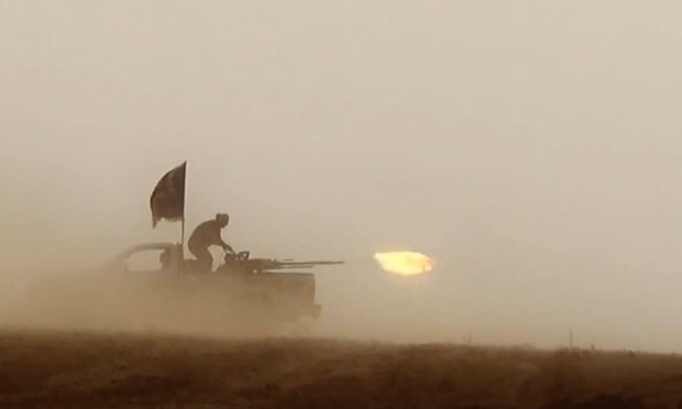 An image grab taken from a propaganda video by the jihadist group the Islamic State of Iraq and the Levant (ISIL) allegedly shows ISIL militants firing from the back of a vehicle near the central Iraqi city of Tikrit.