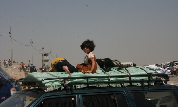 Kalak Checkpoint on Mosul-Irbil. Thousands of people who fled wait in the blistering heat, hoping to enter the safety of the nearby Kurdish region and furious at Baghdad's failure to help them. Photograph: Fazel Hawramy for the Guardian