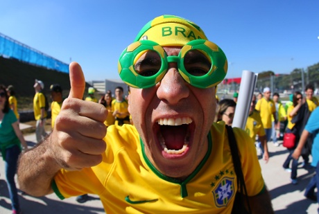 A Brazil fan soak up the atmosphere outside the Itaquerao stadium ahead of kick off in the opening match of the 2014 World Cup vs Croatia
