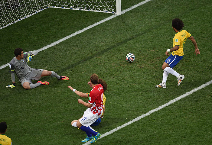 sport-: Brazil's defender Marcelo (TOP) scores a