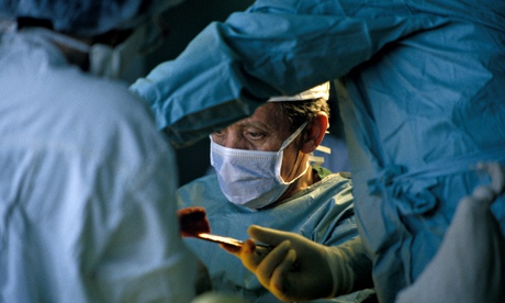 Surgeon conducting hip replacement surgery.