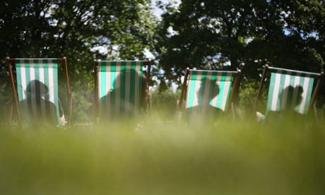 People enjoying the sun in Hyde Park, central London.