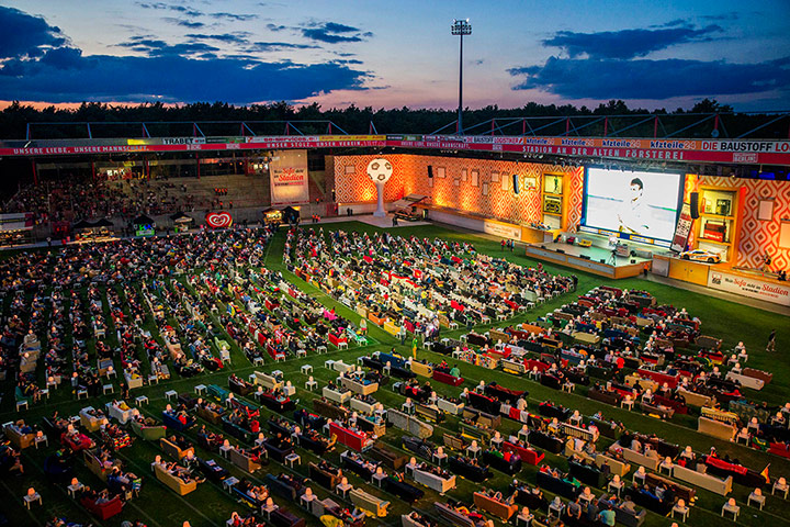 Sofa football: People sit on sofas as they watch the opening game 