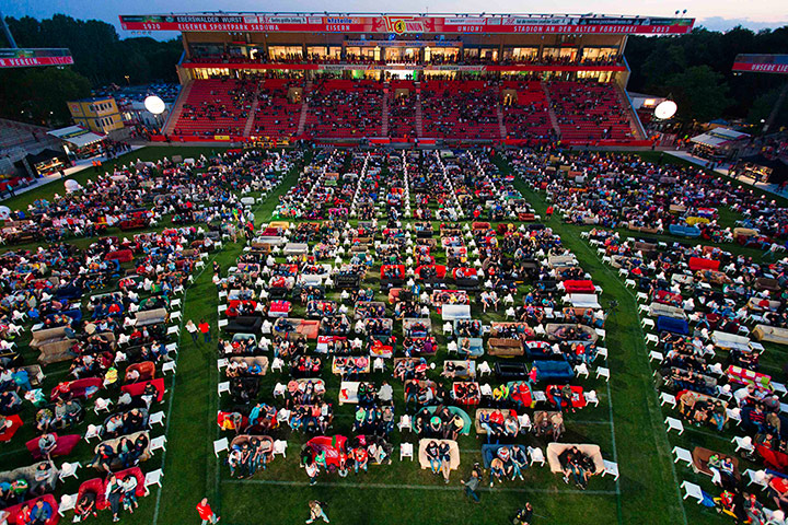Sofa football: People sit on sofas as they watch the opening game of the 2014 World Cup 