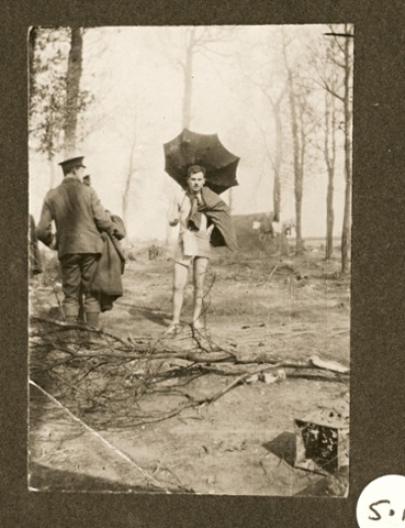 Behind the front lines after taking a dip: this officer carries an umbrella 'borrowed' from a billet in Ypres.