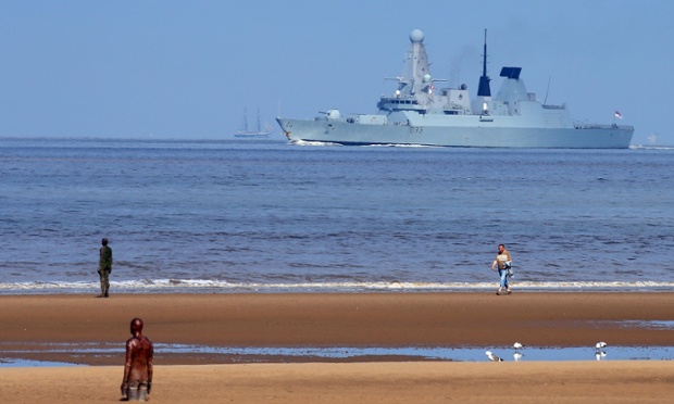 A general view of Antony Gormley's Another Place sculpture on Crosby Beach as HMS Dauntless passes the windfarm just off the beach at Crosby, Merseyside, the boat is part of the Mersey River Festival taking place this weekend in Liverpool.