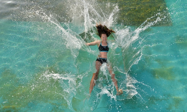 Making a splash in the warm weather at Lymington Sea Water Baths, Hampshire.