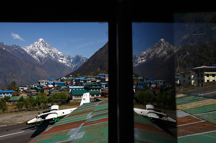 FTA: Ascent to Everest: An aircraft is reflected as it takes off from Tenzing Hillary Airport in Lu