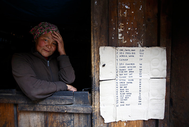 FTA: Ascent to Everest: A woman sits in the window of her shop on the way to Namche in Solukhumbu D