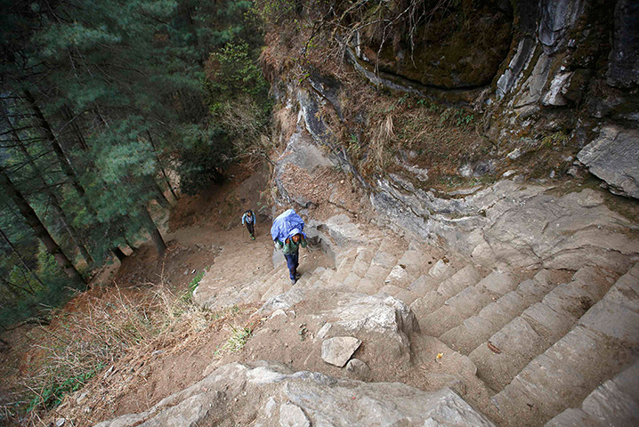 FTA: Ascent to Everest: Porter Lakpa Sherpa, 42, walks along the tracks while on his way to Everest