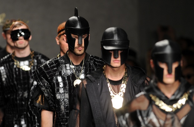 Male models walk the runway at the KTZ show at London menswear fashion week