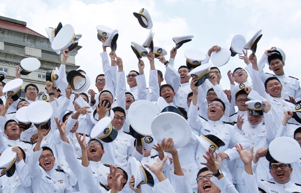 Cadets toss their hats into the air after graduation, during a ceremony marking the 90th anniversary of Taiwan's military academy