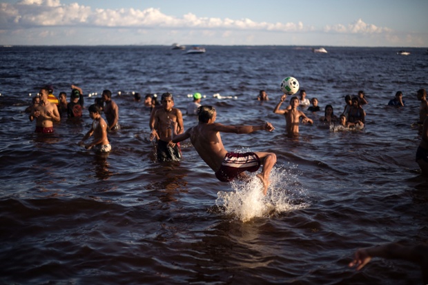Brazilians play football on Ponta Negra beach in Natal, Brazil