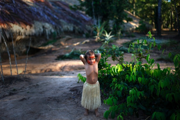 An Indian Tatuyo girl plays at Tupe village on the outskirts of Manaus in the Amazon