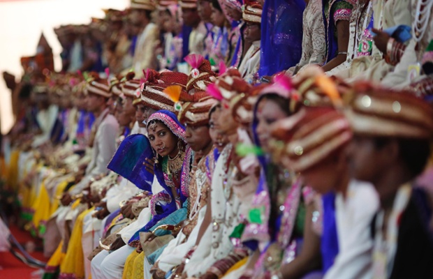 Brides and grooms pose for pictures during a mass wedding ceremony at Ramlila Ground in New Delhi. A total of 92 physically challenged couples of all religions and from across India took their wedding vows on Sunday during the mass wedding ceremony organised by an NGO