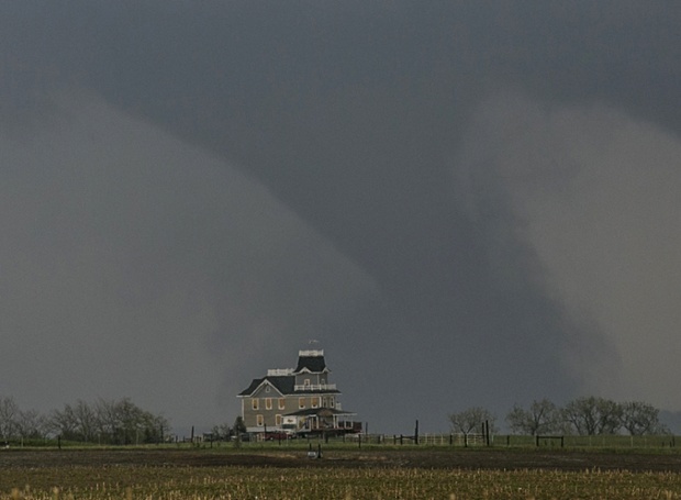 A tornado forms over a house near  Pilger