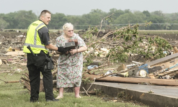 Ruth Labenz is helped to safety by a Stanton County sheriff's officer after her home was destroyed