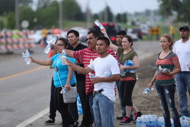Chaplains of the Central Christiano Nueva Viva church in Norfolk hand out bottled water to people following evacuation orders in Pilger