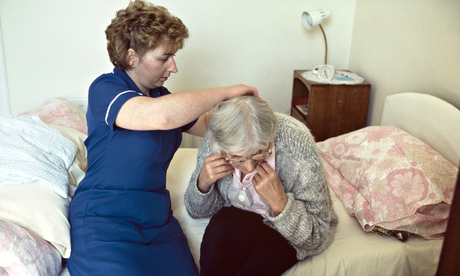 district nurse assisting an old woman at home