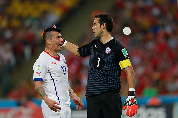 spain v chile : ary Medel celebrates with goalkeeper Claudio Bravo 