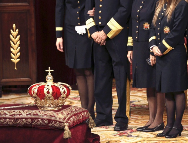 Ushers stand next to the crown inside the hemicycle  before the proclamation to the Parliament of Spain's new King Felipe VI at the Congress of Deputies.