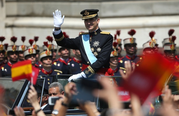 King Felipe VI greets crowds of wellwishers as he arrives at the Royal Palace.