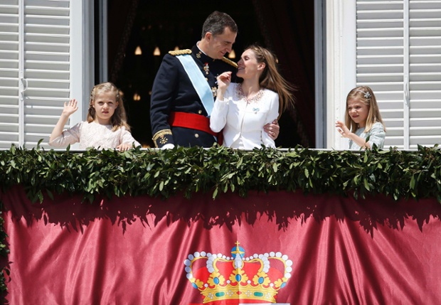 Spain's new King appears on the balcony of the Royal Palace with his family.