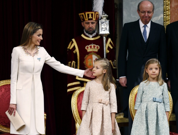 Spain's Queen Letizia reaches over to Princess Leonor of Asturias near Princess Sofia during the official proclamation at the Parliament's Lower House.