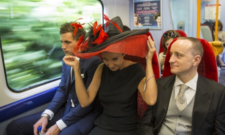 A racegoer adjusts her hat aboard the Ascot Express train direct from Waterloo.
