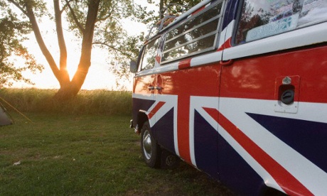 A VW camper van adorned with British union jack colours.