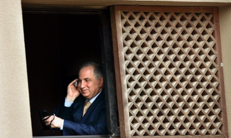 Former Pentagon favourite Ahmad Chalabi twirls his prayer beads whilst making a phone call in Baghdad.
