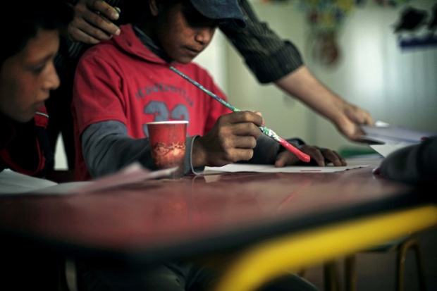 Boy at art class in Syrian refugee camp