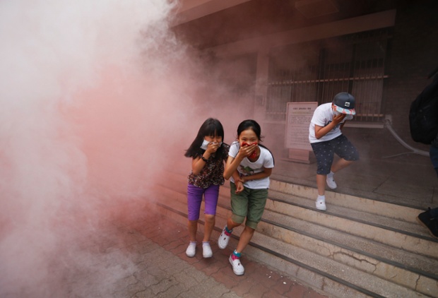 It's only an exercise: South Korean elementary school students take part in a evacuation drill as a in Seoul. Since the sinking of a ferry that killed hundreds, the training was the biggest safety drill in the country, according to local media.
