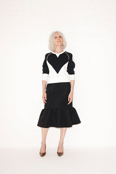 All Ages sporty: black and white sweater black kick flare skirt copper heeled pumps