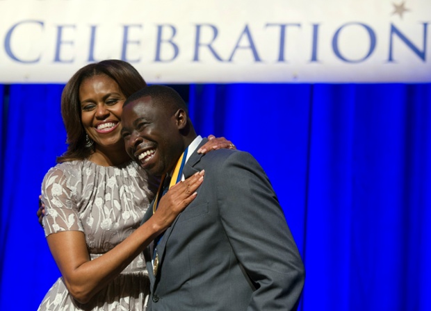 First lady Michelle Obama hugs graduate Isiah Guinyard after he was presented with a Student Achievement Award during the DC College Access Program Class of 2014 graduation celebration in Washington last night.