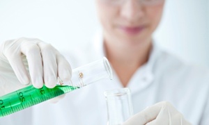 Female scientist pouring liquid from graduated cylinder to test tube