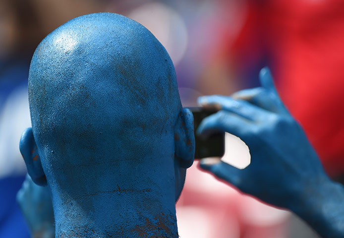 Italy v Costa Rica: TOPSHOTS  A football fan cheers prior to