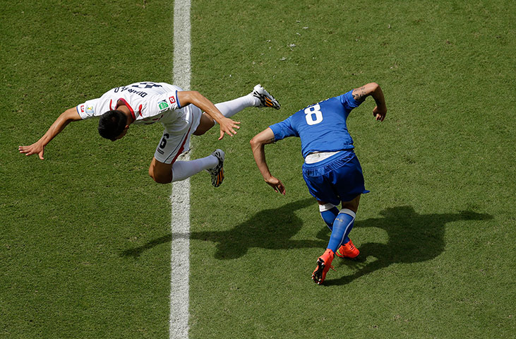 Italy v Costa Rica: Costa Rica's Oscar Duarte falls over Italy's Claudio Marchisio