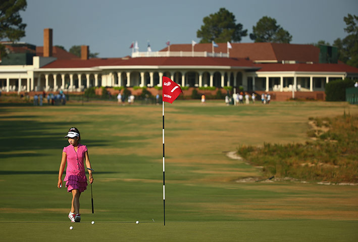 20 photos: 11-year-old amateur Lucy Li of the United States walks on the first green
