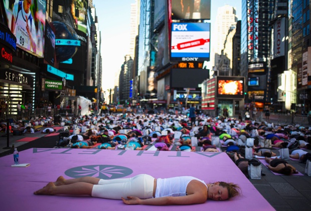 People practise yoga in Times Square, New York, as part of the summer solstice celebrations