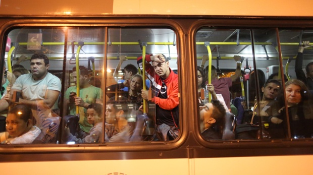 Commuters look out of a bus during an anti-World Cup demonstration in Rio de Janeiro, Brazil.