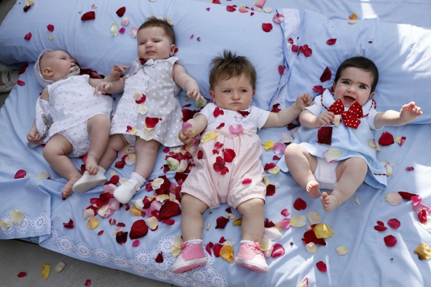 Rose petals cover babies during El Colacho in the village of Castrillo de Murcia. Photograph: Cesar Manso / AFP / Getty Images