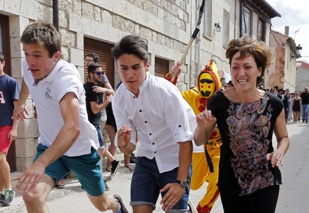 A man dressed up as the devil chases children during El Colacho, the baby jumping festival in the village of Castrillo de Murcia. Photograph: Cesar Manso / AFP / Getty Images