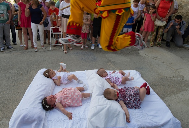 A man representing the devil leaps over babies during El Colacho. Photograph: Denis Doyle / Getty Images