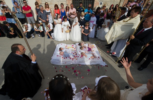 Babies covered in confetti are blessed during el Salto del Colacho in Castrillo de Murcia, Spain. Photograph: Denis Doyle / Getty Images