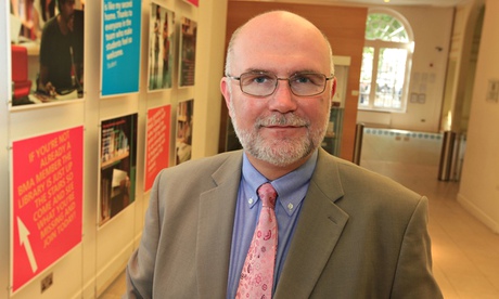 profile photo of dr mark porter in light brown jacket and pink flowery tie