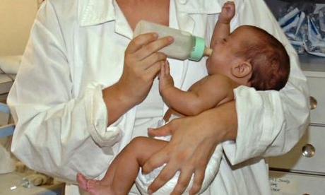Dr. Claudia Guimaraes carries the baby girl in Brazil